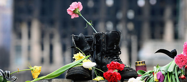 KIEV, UKRAINE - FEBRUARY 25: A pair of boots placed as a memorial to an anti Yanakovych protestor killed in clashes with riot police last week on February 25, 2014 in Kiev, Ukraine. Ukraine's interim President Olexander Turchynov is due to form a unity government, as UK and US foreign ministers meet to discuss emergency financial assistance for the country. (Photo by Jeff J Mitchell/Getty Images)