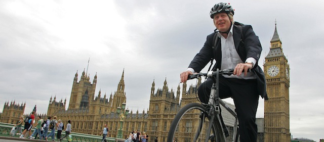 Mayor of London Boris Johnson, cycles his bike over Westminster Bridge in central London on July 30, 2010. London launched a major cycle hire scheme Friday which aims to make transport in the city greener ahead of the 2012 Olympics, following in the tracks of cities like Paris and Shanghai. Johnson, a keen cyclist, said the scheme was a "new dawn" for pedal power in London, adding he hoped the bikes would become as common a sight on its streets as black cabs and red double-decker buses. AFP PHOTO / GEOFF CADDICK (Photo credit should read GEOFF CADDICK/AFP/Getty Images)