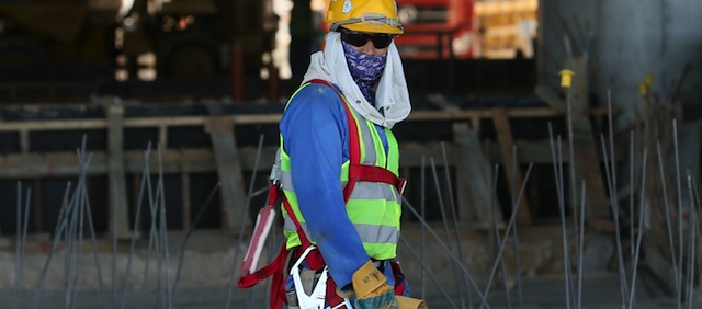 A migrant labourer walks as he works on a construction site on October 3, 2013 in Doha in Qatar. Qatar, the 2022 World Cup host is under fire over claims of using forced labour. Global football's governing body FIFA kicked off a crunch meeting behind closed doors, amid claims of rights abuses by Qatar and wrangling over plans to hold the tournament in the winter. AFP PHOTO / AL-WATAN DOHA / KARIM JAAFAR == QATAR OUT = (Photo credit should read KARIM JAAFAR/AFP/Getty Images)