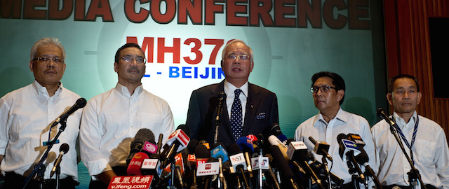 Malaysian Prime Minister Najib Razak (C) addresses the media during a press conference at a hotel near Kuala Lumpur International Airport in Sepang on March 15, 2014. Prime Minister Najib Razak said on March 15 that Malaysia was ending a search in the South China Sea for a vanished jetliner after investigations indicated the missing plane likely turned far to the west. AFP PHOTO/ MANAN VATSYAYANA (Photo credit should read MANAN VATSYAYANA/AFP/Getty Images)