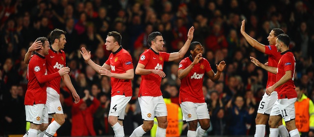 MANCHESTER, ENGLAND - MARCH 19: Robin van Persie of Manchester United celebrates scoring the second goal with his team-mates during the UEFA Champions League Round of 16 second round match between Manchester United and Olympiacos FC at Old Trafford on March 19, 2014 in Manchester, England. (Photo by Laurence Griffiths/Getty Images)