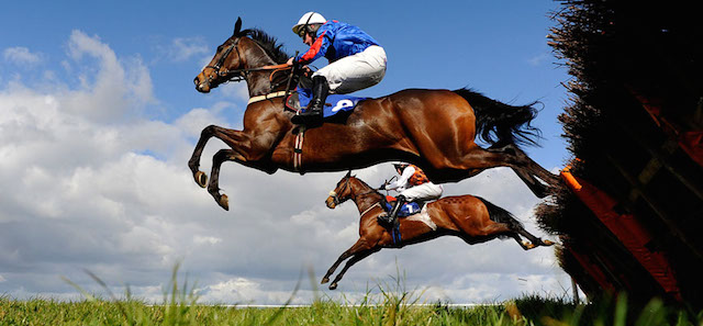 WINCANTON, ENGLAND - MARCH 23: Runners clear a flight of hurdles in the back straight in The Finishing Post @White PostbRimpton Novices Hurdle Race at Wincanton racecourse on March 23, 2014 in Wincanton, England. (Photo by Alan Crowhurst/Getty Images)