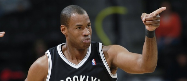 Brooklyn Nets center Jason Collins points to the bench as teammates cheer after Collins made a basket against the Denver Nuggets late in the fourth quarter of the Nets' 112-89 victory in an NBA basketball game in Denver on Thursday, Feb. 27, 2014. (AP Photo/David Zalubowski)