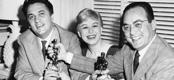 FILE - In this March 28, 1957 file photo, Federico Fellini, left, his wife Giulietta Masina, and Dino De Laurentiis hold the Oscars awarded for "La Strada" in the Hollywood section of Los Angeles, Calif. De Laurentiis, a film impresario and producer of "Serpico," "Barbarella" and "Death Wish," died Wednesday, Nov. 10, 2010 at his home in Beverly Hills, Calif. He was 91. (AP Photo/ Ellis Bosworth, File)