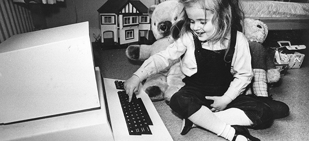8th May 1980: Four-year-old Antonia Salmon with one of her birthday presents,a computer which used to belong to her father. (Photo by Hulton Archive/Getty Images)