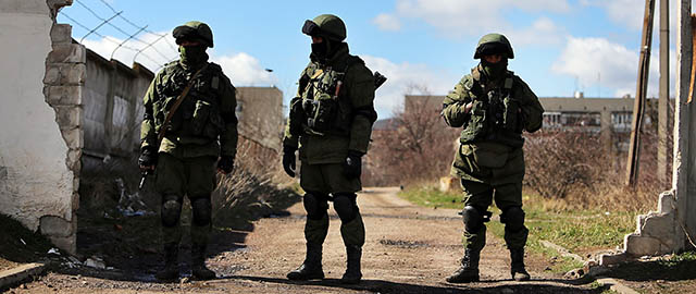 PEREVEVALNE, UKRAINE - MARCH 17: Armed soldiers without identifying insignia keep guard outside of a Ukrainian military base in the town of Perevevalne near the Crimean city of Simferopol on March 17, 2014 in Perevevalne, Ukraine. Voters on the autonomous Ukrainian peninsular of Crimea voted overwhelmingly yesterday to secede from their country and join Russia. (Photo by Spencer Platt/Getty Images)