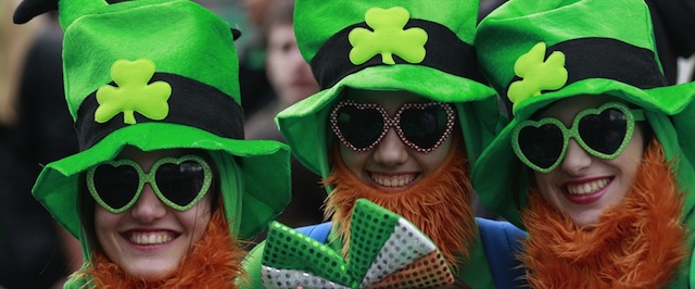 People dress in the emerald green to honour Ireland's Saint Partick, as they enjoy the atmosphere during the St Patrick's day parade in Dublin, Ireland, March, 17, 2014. The world's largest parade celebrating Irish heritage set off on a cold and gray morning, the culmination of a weekend of St. Patrick's Day revelry. (AP Photo/Peter Morrison)