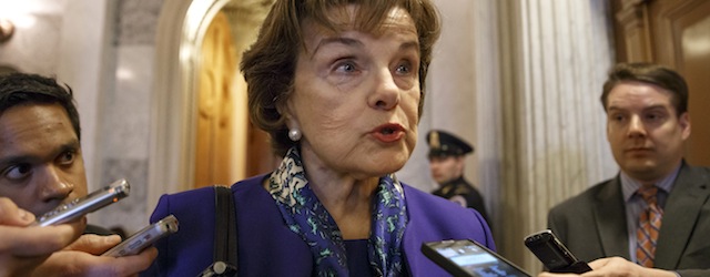 Senate Intelligence Committee Chair Sen. Dianne Feinstein, D-Calif. talks to reporters as she leaves the Senate chamber on Capitol Hill in Washington, Tuesday, March 11, 2014, after saying that the CIA's improper search of a stand-alone computer network established for Congress has been referred to the Justice Department. The issue stems from the investigation into allegations of CIA abuse in a Bush-era detention and interrogation program. (AP Photo/J. Scott Applewhite)