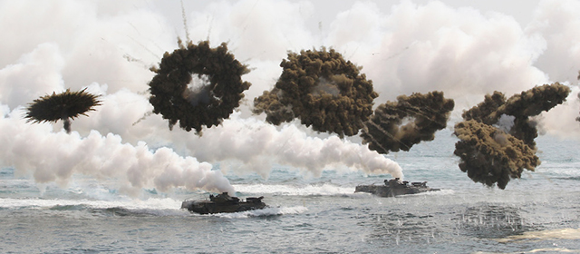 South Korean marine LVT-7 landing craft sail to shores through smoke screens during the U.S.-South Korea joint military exercises called Ssangyong, part of the Foal Eagle military exercises, in Pohang, South Korea, Monday, March 31, 2014. South Korea said North Korea has announced plans to conduct live-fire drills near the rivals' disputed western sea boundary. The planned drills Monday come after an increase in threatening rhetoric from Pyongyang and a series of rocket and ballistic missile launches in an apparent protest against the annual military exercises by Seoul and Washington.(AP Photo/Ahn Young-joon)