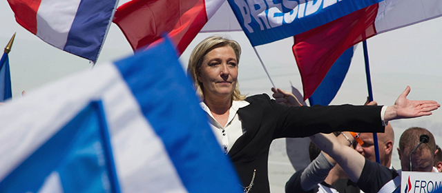 PARIS, FRANCE - MAY 01: Marine Le Pen gestures as she delivers a speech during the French Far Right Party May Day demonstration on May 1, 2012 in Paris, France. Marine Le Pen, the daughter of the French far-right leader Jean-Marie Le Pen, received only 6.4 million votes in the first round of the presidential elections and both Sarkozy and Hollande are now seen as trying to win support from the French Far Right ahead of the second round of voting. (Photo by Pascal Le Segretain/Getty Images)