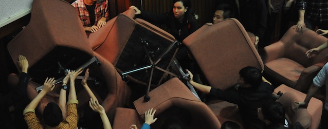 Protesters from anti-China activist groups use chairs to block the entrance to the Taiwanese Parliament as it prepares to pass trade and services agreements with China during a parliamentary session, in Taipei, on March 18, 2014. Hundreds of college students and anti-China demonstrators occupied the Parliament to protest the ruling Kuomintang (KMT) party's decision to pass new trade and services agreements with China. AFP PHOTO / Mandy CHENG