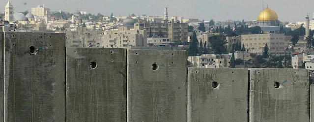 ABU DIS, WEST BANK - JANUARY 9: (ISRAEL OUT) The golden Dome of the Rock Islamic Shrine in Jerusalem's Old City is seen on the horizon behind a section of Israel's controversial 8-meter-high (26 feet) security barrier that is still under construction January 9, 2004 in the Palestinian neighborhood of Abu Dis in the West Bank. Yosef Lapid, Israeli Justice Minister, warned that Israel could be subjected to international boycotts, similar to those placed on South Africa during its apartheid regime, because of the wall. (Photo by Uriel Sinai/Getty Images)