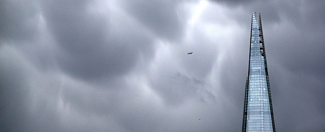 LONDON, UNITED KINGDOM - JANUARY 07: An aeroplane passes rain clouds above The Shard skyscraper on January 7, 2014 in London, England. Over 100 areas of the UK have been warned by the Environment Agency that they are at risk of flooding as a prolonged period of heavy rainfall continues to affect much of the country. (Photo by Oli Scarff/Getty Images)