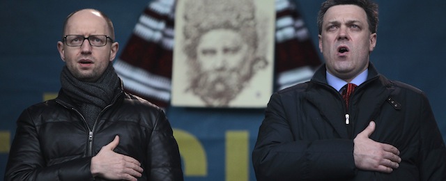 Ukrainian opposition leader Arseniy Yatsenyuk, left, and Ukrainian opposition leader Oleh Tyahnybok sing the national anthem of Ukraine during a rally in Independence Square in Kiev, Ukraine, Sunday, Jan. 12, 2014. Tens of thousands of activists rallied in the center of the Ukrainian capital on Sunday, while the organizers of the weeks-long anti-government protests looked for a future strategy amid dwindling numbers and a continuing government crackdown on the protesters. (AP Photo/Sergei Chuzavkov)