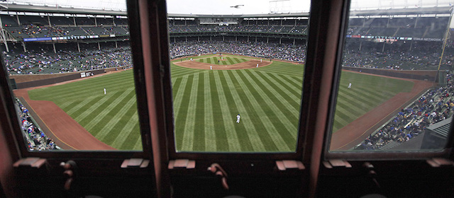 This April 10, 2014 photo shows a view of the field from inside Wrigley Field’s iconic scoreboard during a baseball game between Pittsburgh Pirates and Chicago Cubs, in Chicago. With Boston’s Fenway Park and Wrigley the only two stadiums in the majors with primary manual scoreboards, it has been a job largely shrouded in mystery until the Cubs allowed The Associated Press climb the steel ladder through the steel floor of the scoreboard for a rare visit to mark Wrigley’s 100-year anniversary. (AP Photo/Kiichiro Sato)