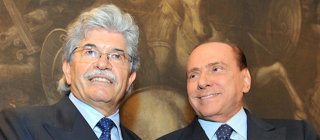 Italy's former Prime Minister Silvio Berlusconi (R) poses with politician Antonio Razzi's during the presentation of Razzi's book "Le mie mani pulite" (My clean hands) on February 1, 2012 at the Italian parliament in Rome. The Clean Hands campaign was a judicial investigation into political corruption in the 1990s. AFP PHOTO / ANDREAS SOLARO (Photo credit should read ANDREAS SOLARO/AFP/Getty Images)
