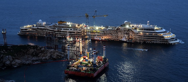 The wreck of Italy's Costa Concordia cruise ship sits in the harbour of Giglio Port on February 26 , 2014. The captain of the wrecked Costa Concordia cruise ship, Francesco Schettino, returned to the site of the disaster for the first time after the judge at his trial ruled he could board the stricken vessel. AFP PHOTO/Filippo MONTEFORTE (Photo credit should read FILIPPO MONTEFORTE/AFP/Getty Images)