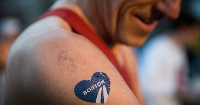 BOSTON, MA - APRIL 21: A runner with a temporary Boston Marathon tattoo gets ready to run the 118th Boston Marathon in the Boston Commons on April 21, 2014 in Boston, Massachusetts. Today marks the 118th Boston Marathon; security presence has been increased this year, due to two bombs that were detonated at the finish line last year, killing three people and injuring more than 260 others. (Photo by Andrew Burton/Getty Images)
