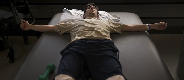 In this photo, part of New York Times photographer Josh Haner's Pulitzer Prize-winning portfolio provided by The New York Times, Jeff Bauman, who lost his lower legs in the Boston Marathon bombings, rests between occupational therapy sessions at Spaulding Rehabilitation Hospital in Boston, May 8, 2013. Bauman went to the Boston Marathon to see his girlfriend run, but now his supporters are watching his plight to walk again after he lost his legs in the bombing. Haner was awarded the 2014 Pulitzer Prize for feature photography, Monday, April 14, 2014, in New York. (AP Photo/The New York Times, Josh Haner)