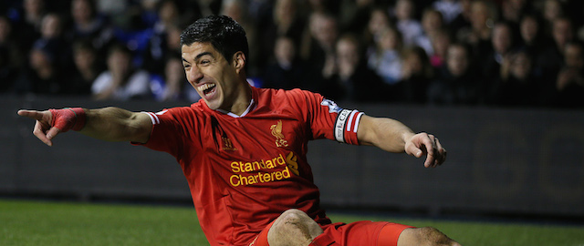 Liverpool's Luis Suarez celebrates after scoring the opening goal during their English Premier League soccer match between Tottenham Hotspur and Liverpool at the White Hart Lane stadium in London, Sunday, Dec.15, 2013. (AP Photo/Alastair Grant)