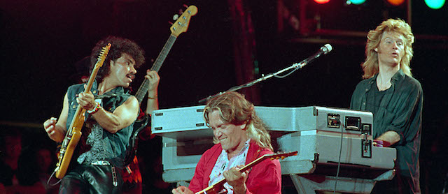 From left, John Oates, G.E.Smith and Daryl Hall perform collectively as Hall and Oates onstage at JFK Stadium in Philadelphia Pa. for the Live Aid famine relief concert July 13, 1985.(AP Photo/Amy Sancetta)