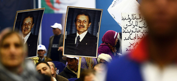 Supporters of Algerian President Abdelazziz Bouteflika (portraits) gather during a political meeting in the city of Tlemcen, some 600 km west of Algiers, ahead of next month's presidential election. Algeria's leader Abdelaziz Bouteflika who is running for re-election appointed Energy Minister Youcef Yousfi as interim premier while outgoing Sellal was tasked with running the ailing president's campaign. AFP PHOTO/FAROUK BATICHE (Photo credit should read FAROUK BATICHE/AFP/Getty Images)