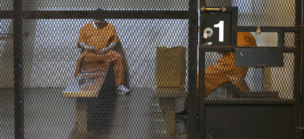 In this photo taken Thursday, Feb. 20, 2014, new arrivals from county jails wait in a holding unit before being assigned to cells at the Deuel Vocational Institution in Tracy, Calif. California counties are thwarting the state's efforts to comply with a federal court order to reduce it's inmate population by sending state prisons far more convicts than anticipated including a record number of second-strikers. The state is trying to comply with a landmark restructuring of its criminal justice system through a nearly 3-year-old law pushed by Gov. Jerry Brown that keeps lower-level felons in county jails while reserving scarce state prison cells for serious, violent and sexual offenders.(AP Photo/Rich Pedroncelli)