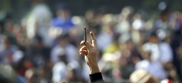 DENVER, CO - APRIL 20: A supporter of legalized marijuana holds up a small blunt as thousands gathered to celebrate the state's medicinal marijuana laws and collectively light up at 4:20 p.m. in Civic Center Park April 20, 2012 in Denver, Colorado on Colorado goes to the polls November 6 to vote on a controversial ballot initiative that would permit possession of up to an ounce of marijuana for those 21 and older. (Photo by Marc Piscotty/Getty Images)