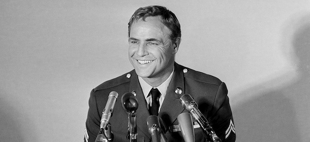 Actor Marlon Brando smiles as he answers a question in Los Angeles, Calif., during a news conference, July 17, 1963 at which he said he will participate in civil rights demonstrations in Maryland even if they are called in defiance of the National Guard ban. (AP Photo)