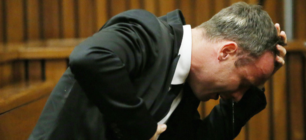 South African Paralympic track star Oscar Pistorius reacts as he listens to evidence by a pathologist during his trial in court in Pretoria on April 7, 2014. As the defence opens its case, the 27-year-old Paralympian will give the court his first account of why he shot dead his model girlfriend Reeva Steenkamp in the early hours of Valentine's Day in 2013. AFP PHOTO / POOL / THEMBA HADEBE (Photo credit should read THEMBA HADEBE/AFP/Getty Images)
