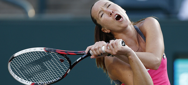 Jelena Jankovic, of Serbia, reacts during a match against Ajla Tomljanovic, of Croatia, at the Family Circle Cup tennis tournament in Charleston, S.C., Thursday, April 3, 2014. (AP Photo/Mic Smith)