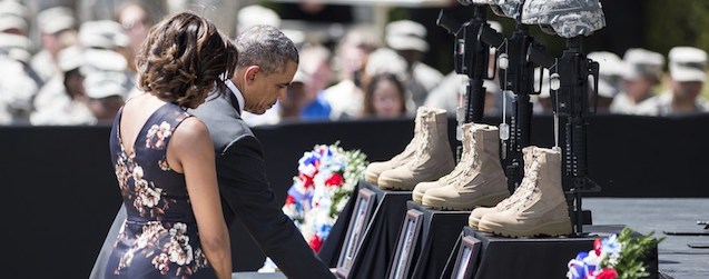 US President Barack Obama and First Lady Michelle Obama pay their respects during a memorial service at Fort Hood April 9, 2014 in Texas. US President Barack Obama attended the memorial service for the 3 killed and 16 wounded during last weeks shooting at the post by Army Specialist Ivan Lopez who later took his own life. AFP PHOTO/Brendan SMIALOWSKI (Photo credit should read BRENDAN SMIALOWSKI/AFP/Getty Images)