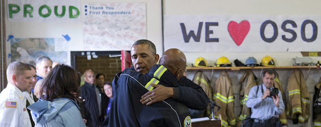 President Barack Obama embraces Jon Lovick, Snohomish County Executive, after speaking to speaks to first responders, recovery workers and community members at the Oso Fire Department in Oso, Wash., Tuesday, April 22, 2014, the site of the deadly mudslide that struck the community in March. (AP Photo/Carolyn Kaster)