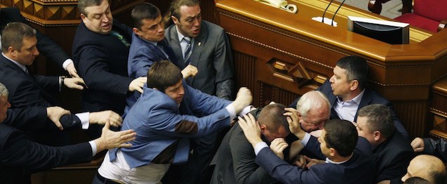 Members of Parliament of the Svoboda party fight with Members of Parliament of the Communist party in the Ukrainian parliament on April 8, 2014, during the debates focused on a law toughening responsibility for separatism. Ukraine's acting president said today he would treat Russian separatists who have seized buildings in the east of the country as "terrorists" who will be prosecuted with the full force of the law. AFP PHOTO/ YURIY KIRNICHNY (Photo credit should read YURIY KIRNICHNY/AFP/Getty Images)