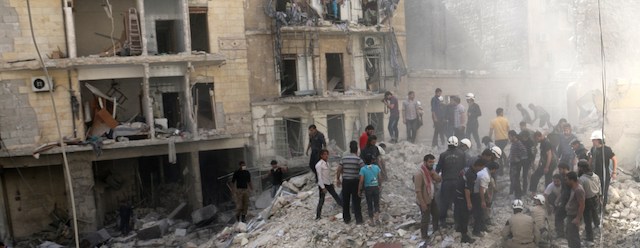 People inspect the rubble after a building collapsed following a reported bombardment with explosive-packed "barrel bombs" by Syrian government forces in the al-Mowasalat neighborhood of the northern Syrian city of Aleppo on April 27, 2014. Aleppo is divided between government and opposition control, and clashes on the ground, rebel fire and regime aerial bombardment have all increased there in recent weeks. AFP PHOTO / ALEPPO MEDIA CENTRE / ZEIN AL RIFAI (Photo credit should read ZEIN AL-RIFAI/AFP/Getty Images)