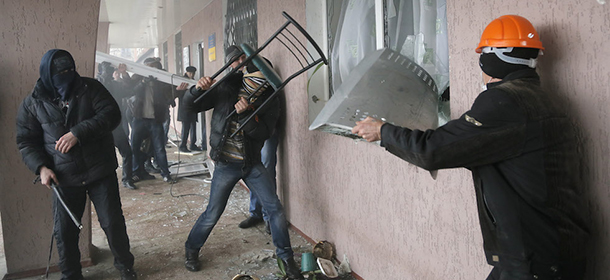 Pro-Russian men storm a police station in the eastern Ukrainian town of Horlivka on Monday, April 14, 2014. Several government buildings have fallen to mobs of Moscow loyalists in recent days as unrest spreads across the east of the country. (AP Photo/Efrem Lukatsky)
