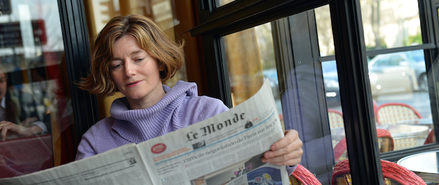 French journalist Natalie Nougayrede holds Le Monde newspaper while posing on February 22, 2013 in Paris. Nougayrede, 46, the newly elected director of the French newpaper Le Monde and the first woman to hold this post, is pictured on March 1, 2013 in Paris. AFP PHOTO / MIGUEL MEDINA (Photo credit should read MIGUEL MEDINA/AFP/Getty Images)