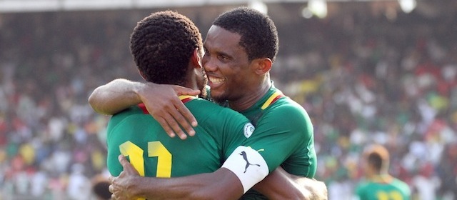 Cameroon striker Samuel Eto'o (R) hugs teammate Jean Makoun after he scored against Tunisia on November 17, 2013 during a 2014 FIFA World Cup second leg qualifying football match in Yaounde. AFP PHOTO / STRINGER (Photo credit should read STRINGER/AFP/Getty Images)