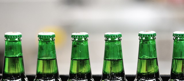 A view of Heineken beer bottles on a conveyor belt at the Heineken brewery in Mons-en-Baroeul, run by the Heineken France group, on April 2, 2014. AFP PHOTO / PHILIPPE HUGUEN