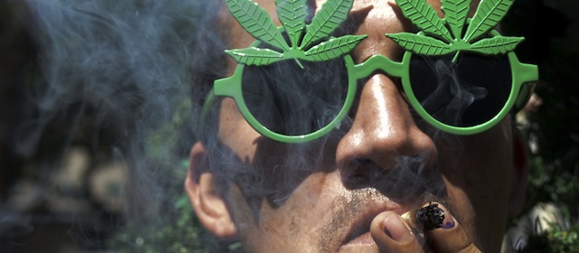 A man smokes marijuana during the World Day for the Legalization of Marijuana in Medellin, Antioquia department, Colombia on May 3, 2014. AFP PHOTO/Raul ARBOLEDA (Photo credit should read RAUL ARBOLEDA/AFP/Getty Images)