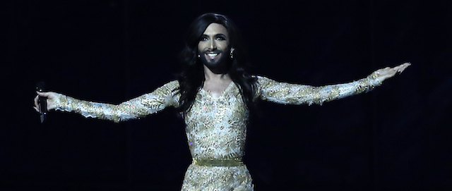 Singer Conchita Wurst representing Austria performs the song ' Rise Like a Phoenix' during a rehearsal for the second semifinal of the Eurovision Song Contest in the B&W Halls in Copenhagen, Denmark, Wednesday, May 7, 2014. Conchita Wurst also known by his birth-name Thomas Neuwirth. Challenging conceptions of masculine and feminine beauty, Wurst seems to have stolen the limelight ahead of the televised extravaganza, with a potential worldwide audience of some 170 million viewers, sporting long and curly raven-dark hair, eyelash extensions, an angelic face, a floor-length golden gown and a well-groomed beard.(AP Photo/Frank Augstein)