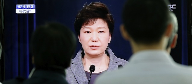 People watch a TV live program showing South Korean President Park Geun-hye's televised speech to the nation about the sunken ferry Sewol at the Seoul Train Station in Seoul, South Korea, Monday, May 19, 2014. South Korea's president said Monday she will push to disband the coast guard in the wake of last month's ferry disaster that left more than 300 people dead or missing, calling its rescue operations after the disaster a failure. (AP Photo/Lee Jin-man)