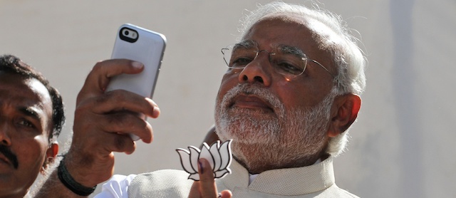 India's main opposition Bharatiya Janata Party(BJP) prime ministerial candidate Narendra Modi takes selfie by his mobile after casting his vote in Ahmadabad, India, Wednesday, April 30, 2014. (AP Photo/Ajit Solanki)