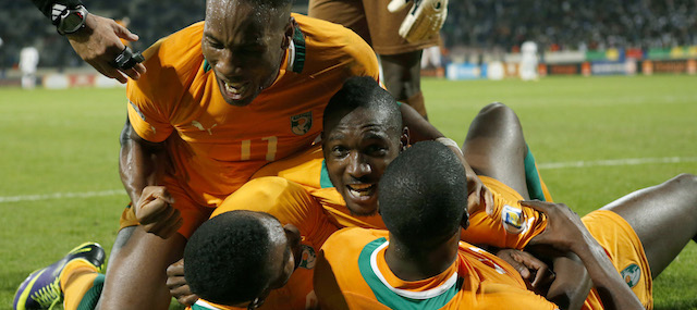 Ivory Coast's Didier Drogba, left, celebrates with his teammates after scoring a goal in a World Cup 2014 qualifying match between Ivory Coast and Senegal at Mohammed V stadium in Casablanca, Morocco, Saturday Nov. 16, 2013. Ivory Coast qualified for the World Cup tournament by beating Senegal 4-2 on aggregate in a playoff for next year's finals in Brazil after a 1-1 draw. (AP Photo/Abdeljalil Bounhar)