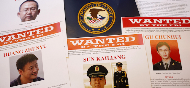 Press materials are displayed on a table of the Justice Department in Washington, Monday, May 19, 2014, before Attorney General Eric Holder was to speak at a news conference. Holder was announcing that a U.S. grand jury has charged five Chinese hackers with economic espionage and trade secret theft, the first-of-its-kind criminal charges against Chinese military officials in an international cyber-espionage case. (AP Photo/Charles Dharapak)