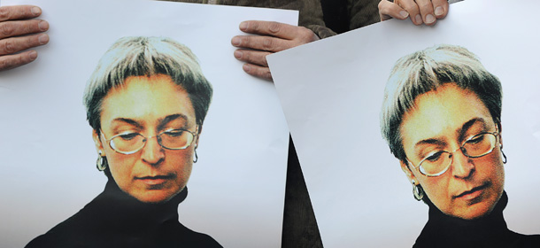 Russian human rights activists attend a rally in honour of slain Russian journalist Anna Politkovskaya in Moscow on October 7, 2010. The Russian investigative journalist, known for her critical coverage of the war in Chechnya, was found murdered 07 October 2006 in the hallway of the building where she lived in Moscow. AFP PHOTO / NATALIA KOLESNIKOVA (Photo credit should read NATALIA KOLESNIKOVA/AFP/Getty Images)