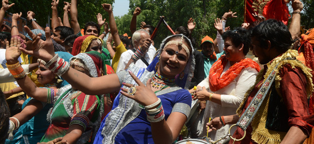 Indian supporters of Bharatiya Janata Party (BJP) celebrate their party victory in front of the BJP headquarters in New Delhi on May 16, 2014. India's frontrunner to be prime minister Narendra Modi announced victory of his Hindu nationalist Bharatiya Janata Party through his Twitter handle even as counting of votes was underway. Triumphant Modi wrote "India has won. Good days are coming." AFP PHOTO/RAVEENDRAN (Photo credit should read RAVEENDRAN/AFP/Getty Images)