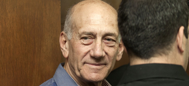 Former Israeli Prime Minister Ehud Olmert waits before the start of a hearing in his trial for corruption linked to a major property development on March 31, 2014 at Tel Aviv District Court. The court found Olmert guilty of bribery linked to the construction of the massive Holyland residential complex when he served as the city's mayor, in one of the worst corruption scandals in Israeli history. AFP PHOTO / POOL / DAN BALILTY (Photo credit should read DAN BALILTY/AFP/Getty Images)