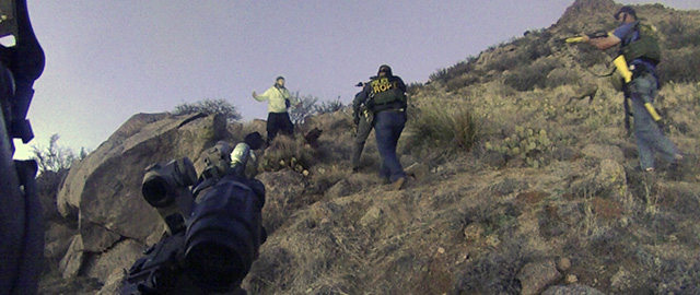 FILE - This March 16, 2014 photo of an Albuquerque Police Department lapel camera still, shows a standoff with an illegal camper in the Albuquerque foothills, before firing six shots at the man. Police say James Boyd, 38, refused to drop a knife and had threatened to kill officers. He later died at a nearby hospital. Faced with a rash of questionable police shootings across New Mexico, the state's main law enforcement academy has changed its cadet curriculum aimed at helping reduce deadly force encounters between officers and suspects. (AP Photo/Albuquerque Police Department)