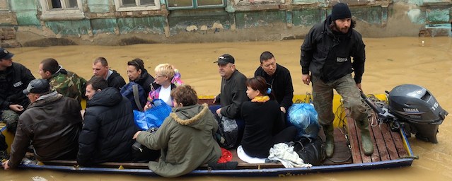 A group is evacuated by boat over flooded streets in the town of Obrenovac, 40 kilometers west of Belgrade, on May 17, 2014. Deadly floods across Bosnia and Serbia have claimed at least 14 lives and led to the evacuation of 15,000 people after the Balkans suffered its heaviest rainfall in a century, officials said on Saturday. AFP PHOTO / ALEXA STANKOVIC (Photo credit should read ALEXA STANKOVIC/AFP/Getty Images)